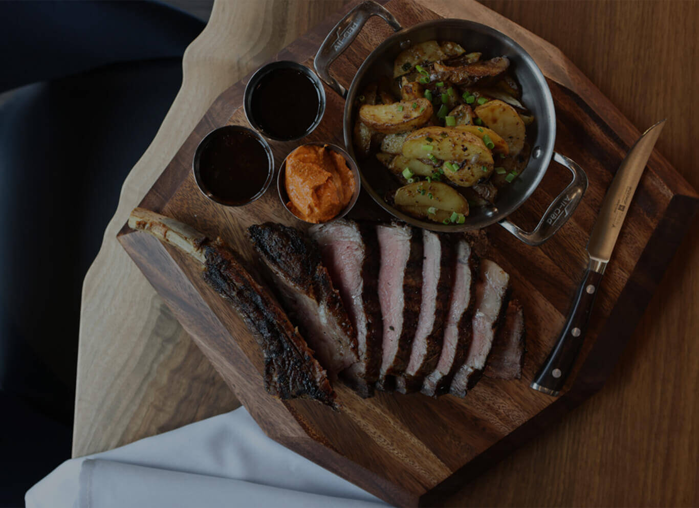 Cleaver and Cocktail restaurant steak cut up on wooden board